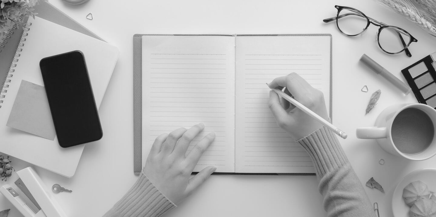 Photo Of Person Writing On Notebook